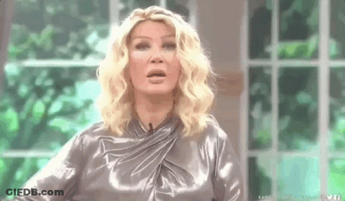 Woman In Silver Dress Making Funny Face GIF