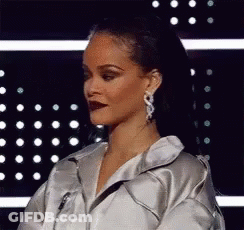 Woman In Silver Jacket And Earrings GIF