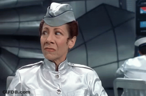 Woman In Silver Uniform Making Silly Face GIF