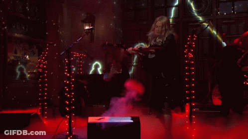 Woman In Skeleton Costume At Microphone In Dark Room GIF