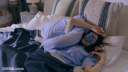 Woman In Sleep Mask Lying In Bed GIF