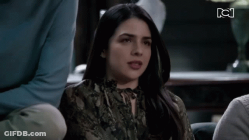 Woman In Snake Print Shirt Sitting With People GIF