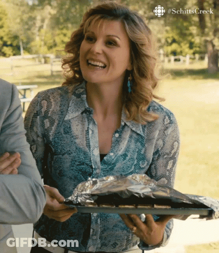 Woman In Snake Print Shirt Smiling With Food GIF
