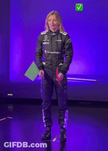 Woman In Snapdragon Jacket Holding Green Flag GIF