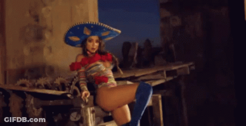 Woman In Sombrero And Blue Boots Sitting On Bench GIF