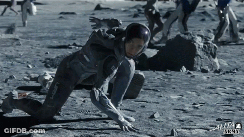 Woman In Space Suit Crawling On Ground With Text Alita Army GIF