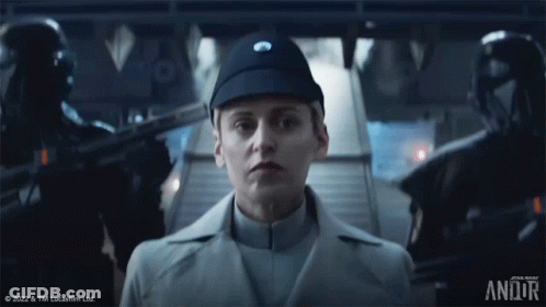 Woman In Star Wars Uniform Standing In Front Of Staircase GIF