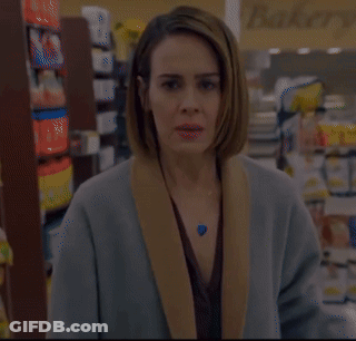 Woman In Store With Fields Sign GIF
