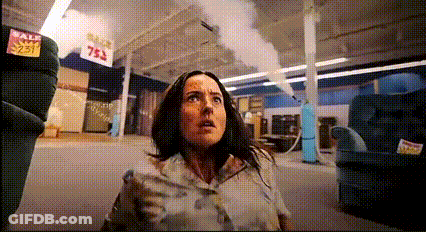 Woman In Store With Sale Sign GIF