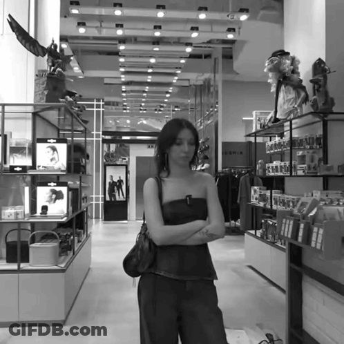 Woman In Store With Sign Saying Sofia GIF