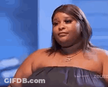 Woman In Strapless Dress And Necklace Looking At Camera GIF