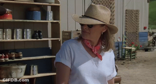Woman In Straw Hat And Bandana By Shelf GIF