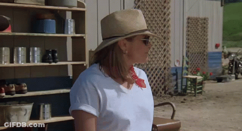 Woman In Straw Hat And Sunglasses Near Shelf Of Cans GIF