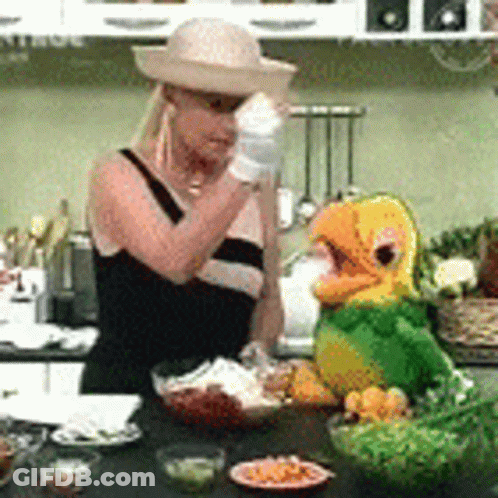 Woman In Straw Hat Next To Stuffed Parrot GIF