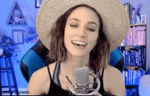 Woman In Straw Hat Talking Into Microphone GIF