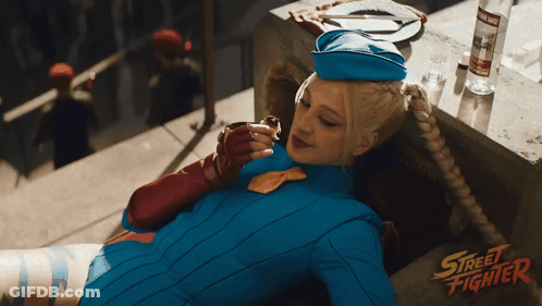 Woman In Street Fighter Costume On Balcony GIF