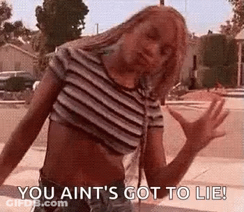Woman In Striped Crop Top Arms Outstretched On Sidewalk GIF