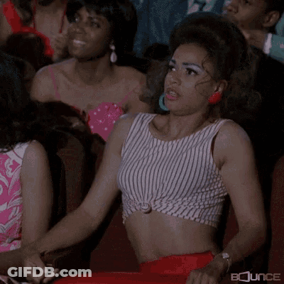 Woman In Striped Crop Top Sitting In Theatre GIF