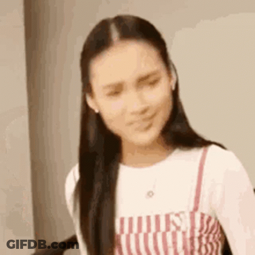 Woman In Striped Dress Making Funny Face GIF