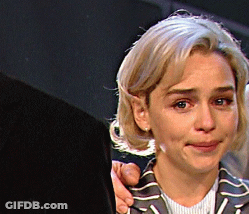 Woman In Striped Jacket Held By Man GIF