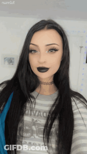 Woman In Striped Motorcycle Shirt And Choker Looking At Camera GIF
