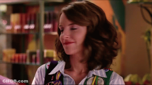 Woman In Striped Shirt And Green Vest Saying Texas GIF