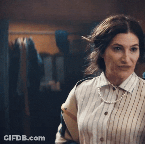 Woman In Striped Shirt And Pearls Looking At Camera GIF