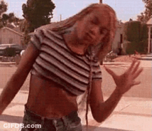 Woman In Striped Shirt And Shorts On Sidewalk GIF