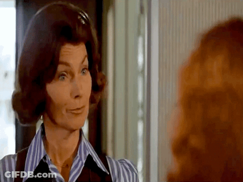 Woman In Striped Shirt And Vest Looking At Woman GIF