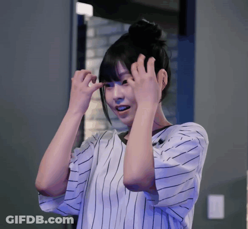 Woman In Striped Shirt Holding Hair GIF
