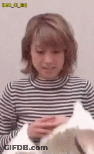 Woman In Striped Shirt Holding Hero 41 Day Paper GIF