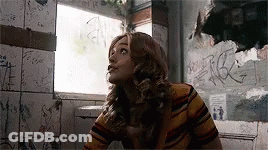 Woman In Striped Shirt In Bathroom With Graffiti GIF