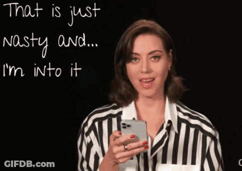 Woman In Striped Shirt Looking At Phone GIF