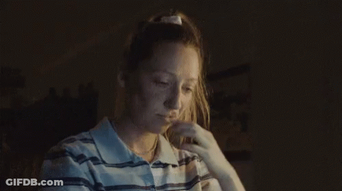 Woman In Striped Shirt Looking Down GIF
