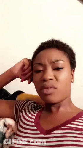 Woman In Striped Shirt Making Funny Face With Hand On Ear GIF
