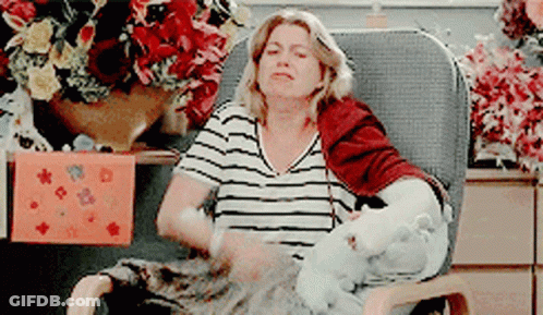 Woman In Striped Shirt Sitting With Stuffed Animal GIF