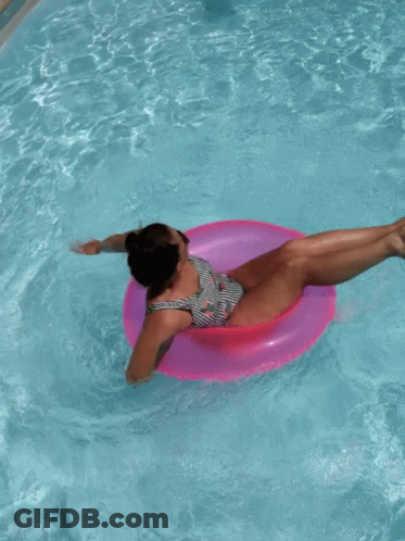 Woman In Striped Swimsuit On Pink Float GIF