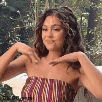 Woman In Striped Top Making Heart Shape GIF