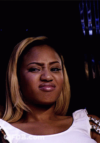Woman In Studded Tank Top Making Funny Face GIF