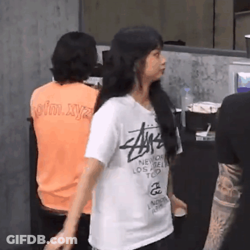 Woman In Stussy T-Shirt Standing In Front Of Group GIF