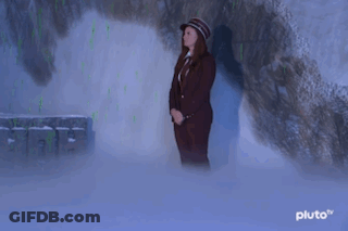 Woman In Suit And Hat In Cave GIF