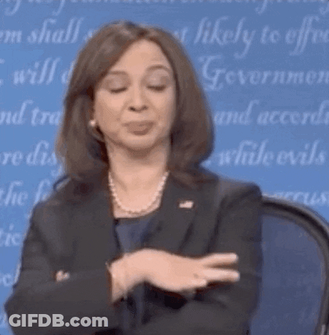 Woman In Suit And Pearl Necklace Making Funny Face GIF