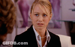 Woman In Suit And Pearls Looking GIF