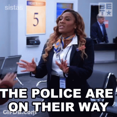 Woman In Suit And Scarf Talking At Airport GIF