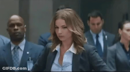 Woman In Suit And Striped Shirt Facing Suits GIF