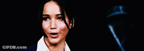 Woman In Suit And Tie Funny Face Pointing At Camera GIF