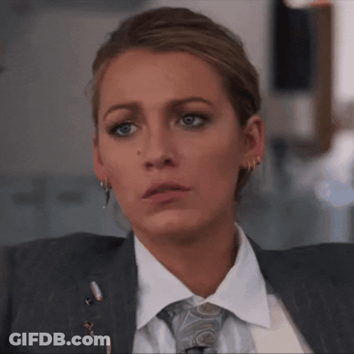Woman In Suit And Tie Looks Serious GIF