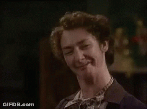 Woman In Suit And Tie Making Funny Face GIF