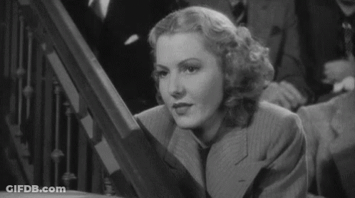 Woman In Suit And Tie On Staircase GIF