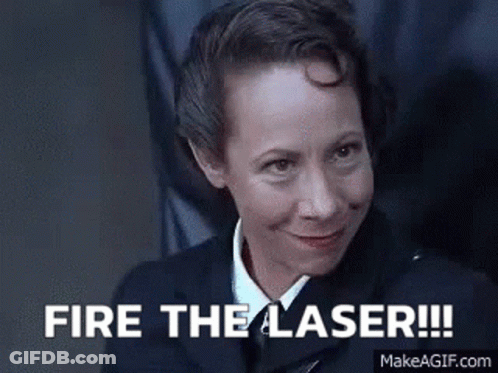 Woman In Suit And Tie Saying Fire The Laser GIF